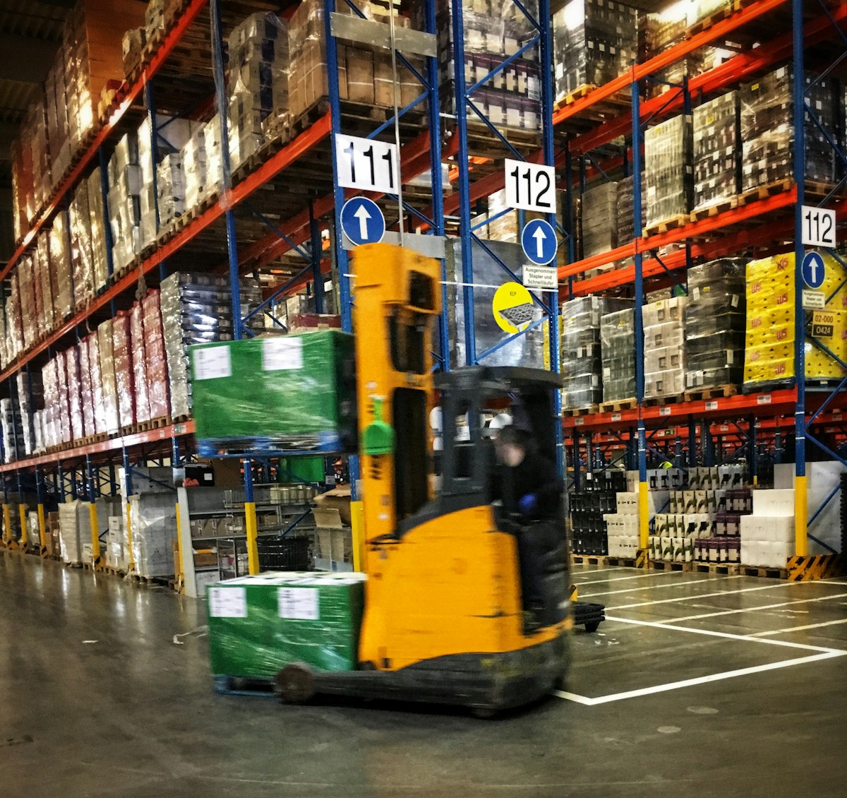 Forklift moving pallets through a warehouse